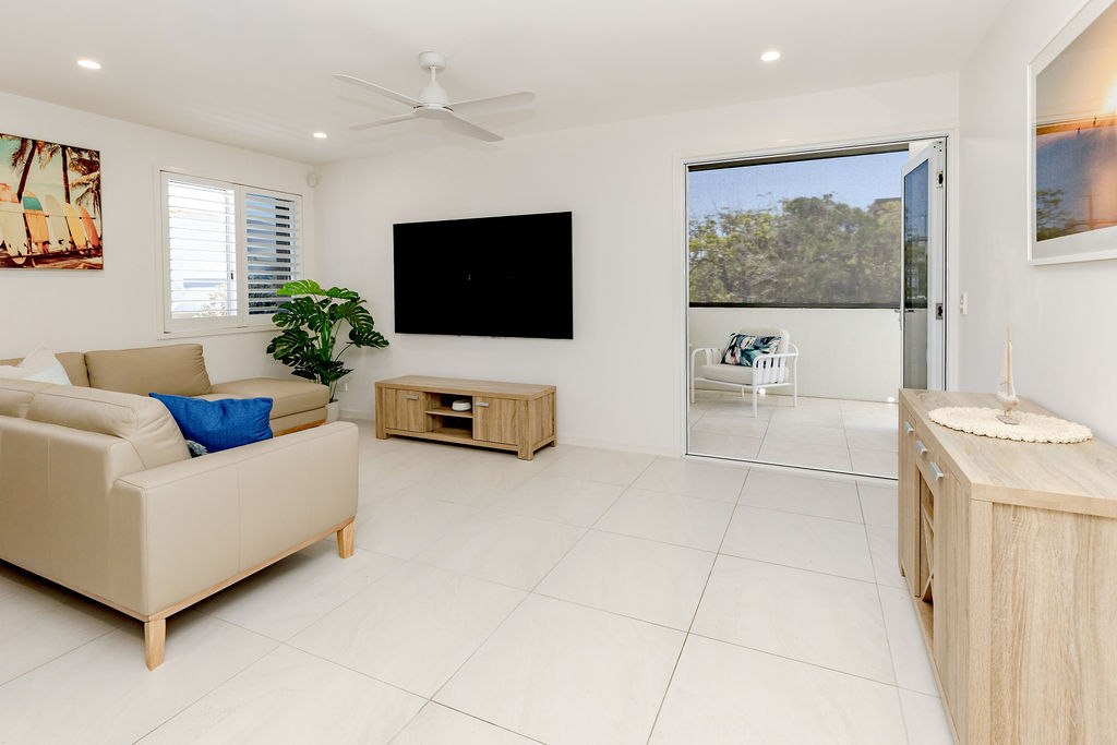 Bright, open living area with coastal styling at the Coolum Beach accommodation