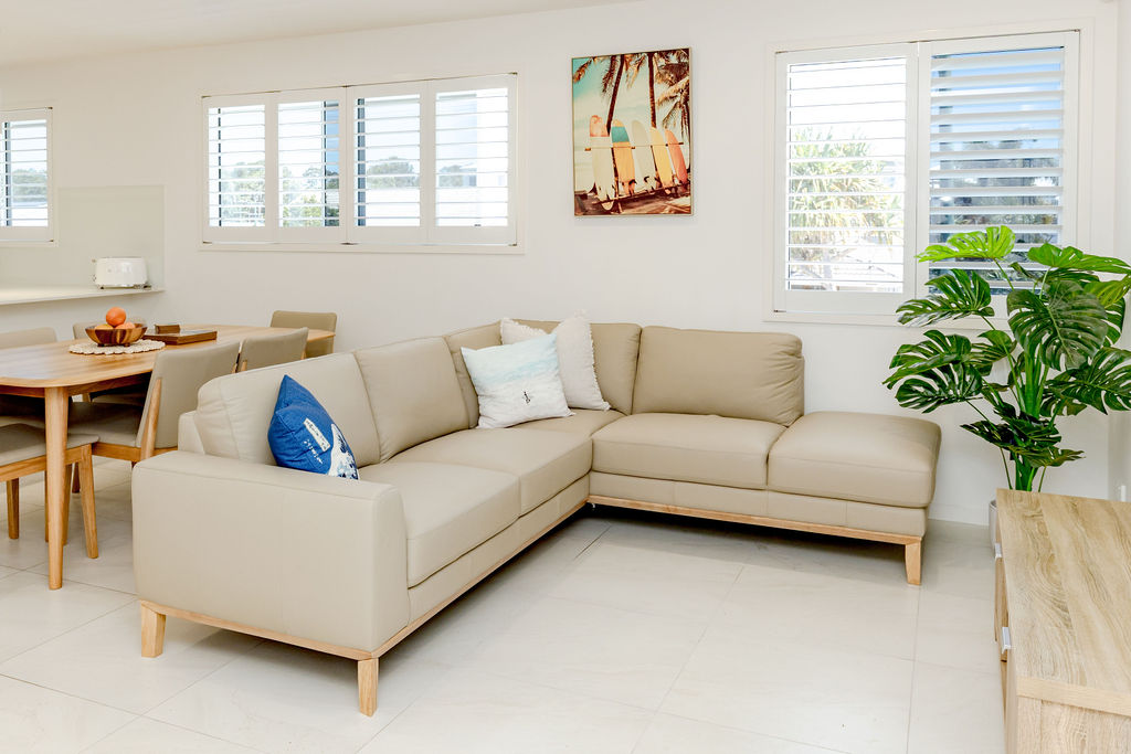 Living and dining area with beachy artwork and natural light